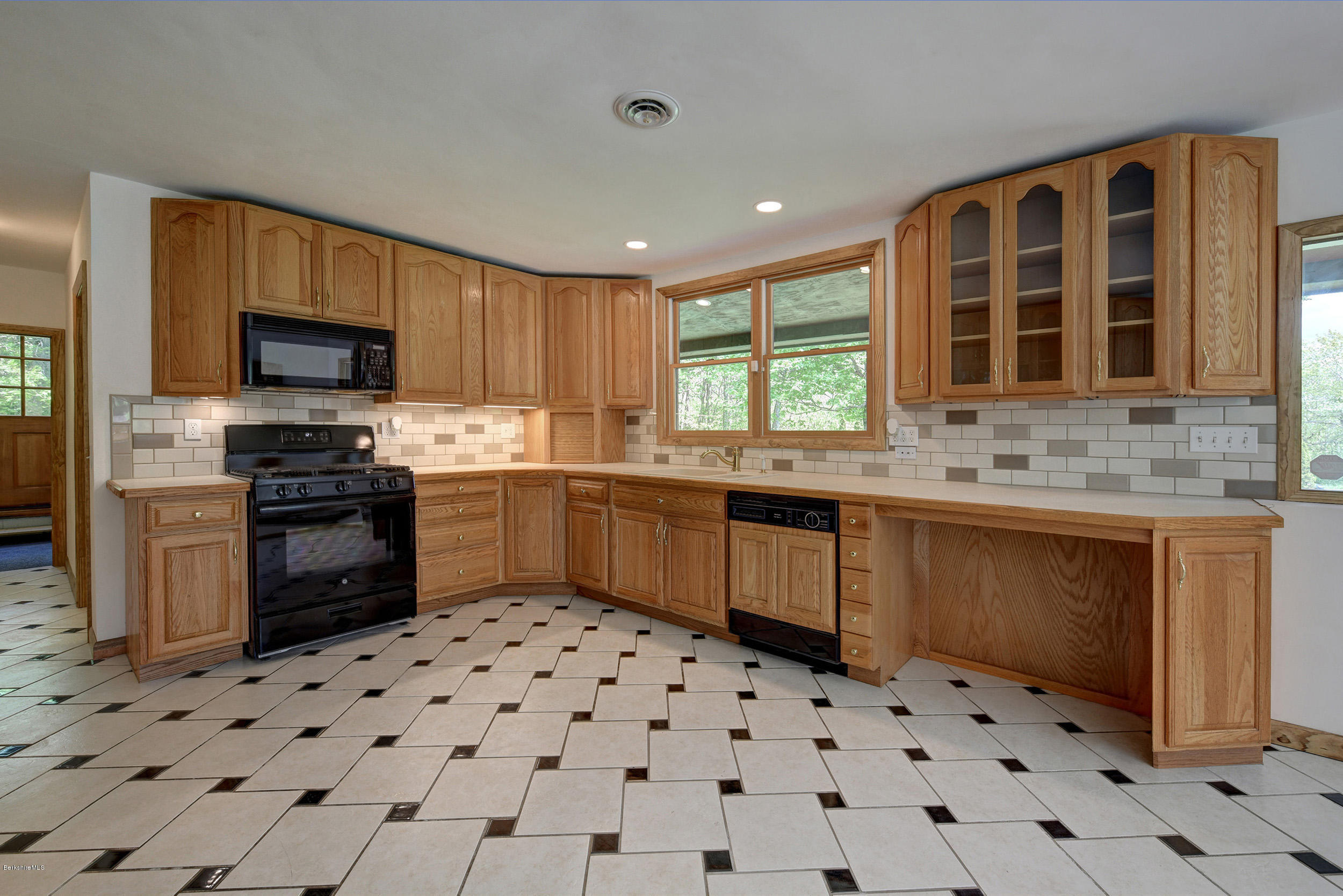 5 N Road Peru, MA 01235 - Photo 10 of 43 a kitchen with a stove a sink a microwave and cabinets