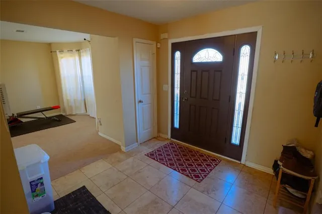 a view of room with a mirror and a wooden floor
