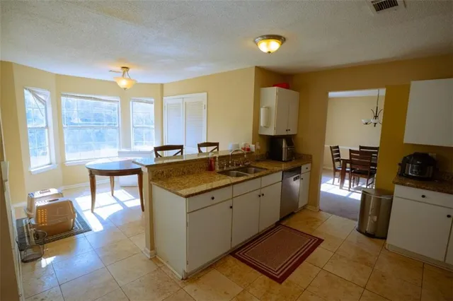 a kitchen with sink and refrigerator