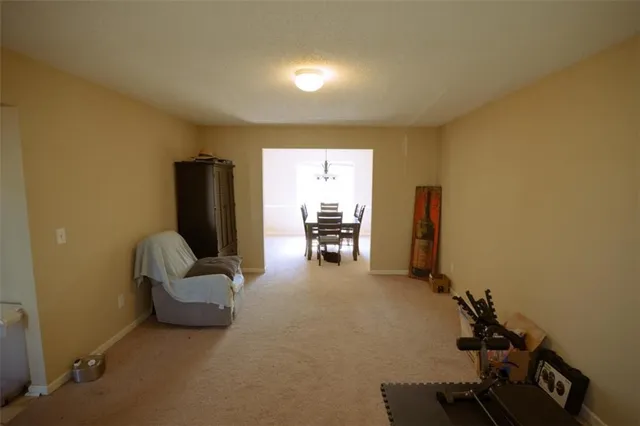 a view of a livingroom with furniture and a ceiling fan