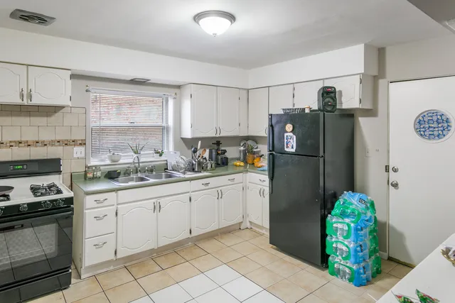 a kitchen with stainless steel appliances granite countertop a refrigerator and a stove