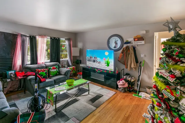 a living room with furniture a window and a flat screen tv