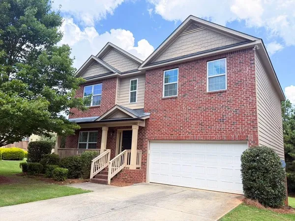 a large kitchen with stainless steel appliances granite countertop a refrigerator and a stove top oven