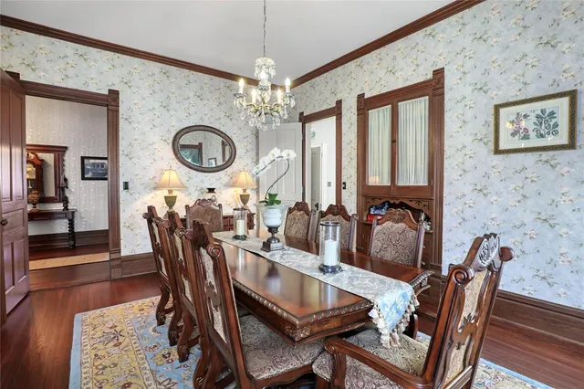a view of a dining room with furniture and chandelier