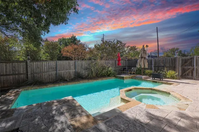a view of a backyard with swimming pool