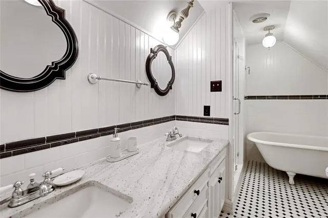 a bedroom with a bed a large window with table and chairs