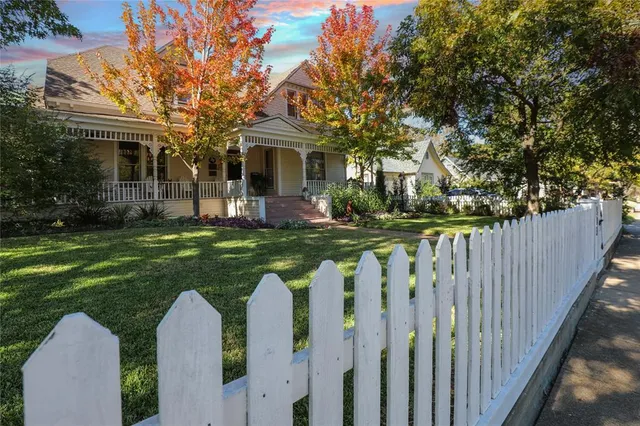 a view of a house with a wooden fence