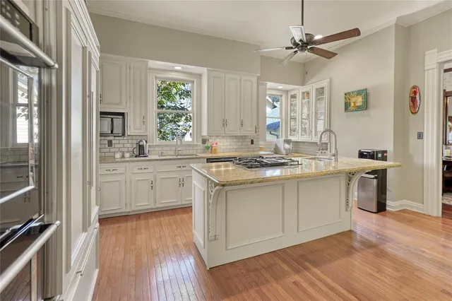 a kitchen with a sink stove and cabinets