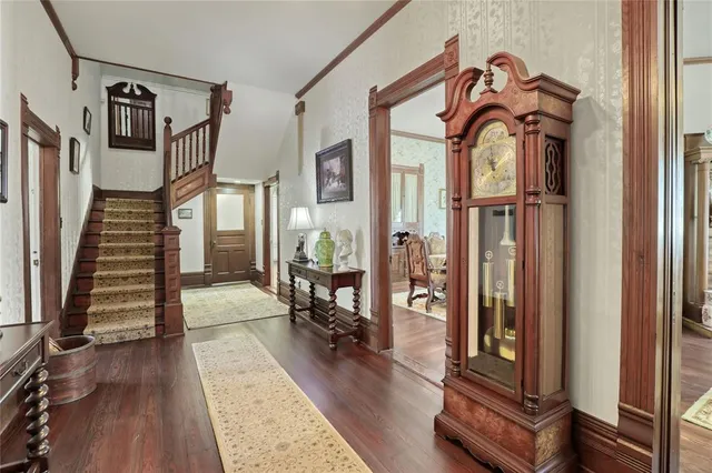 a view of a livingroom with wooden floor and furniture
