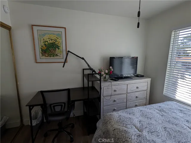 a bedroom with a bed and a window