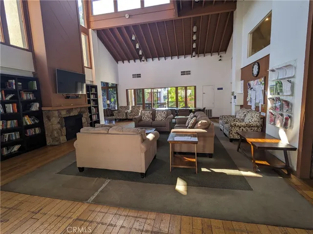 a living room with patio furniture and a fireplace