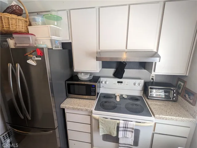 a kitchen with a stove and a refrigerator