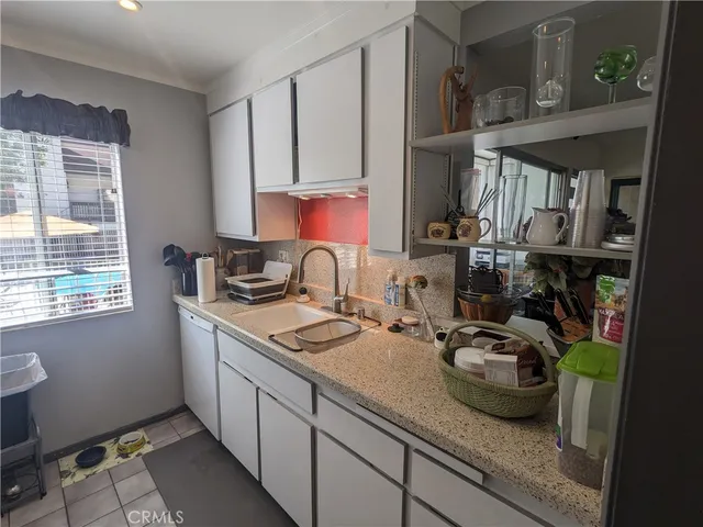 a kitchen with sink a stove and cabinets