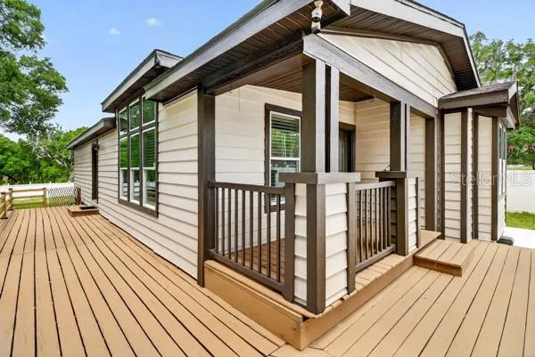 a view of a wooden door front of a house
