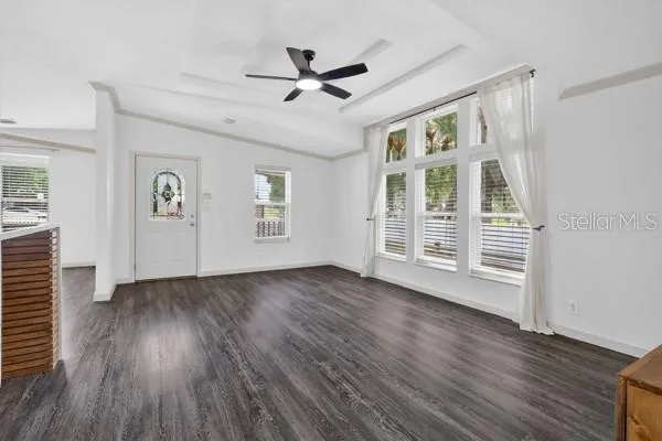 a view of empty room with wooden floor and window