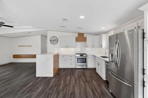 a kitchen with a stove cabinets and wooden floor
