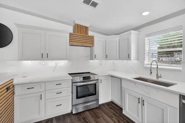 a kitchen with a sink stove and refrigerator