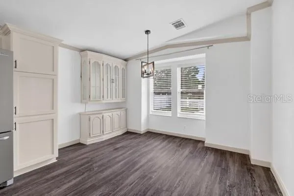 a kitchen with wooden floors and appliances