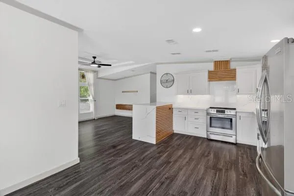 a kitchen with stainless steel appliances a refrigerator and a stove top oven