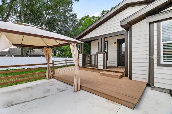 a front view of a house with backyard and sitting area