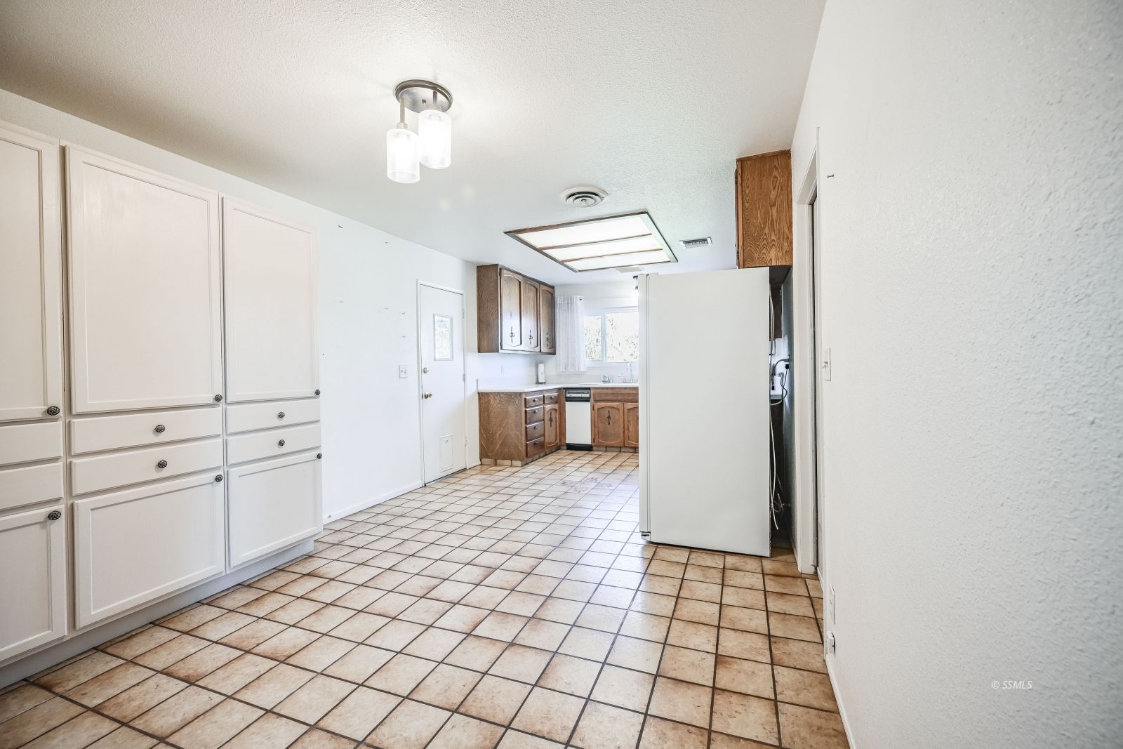 221 South Silver Ridge Street Ridgecrest, CA 93555 - Photo 20 of 44 a view of a kitchen with white cabinets