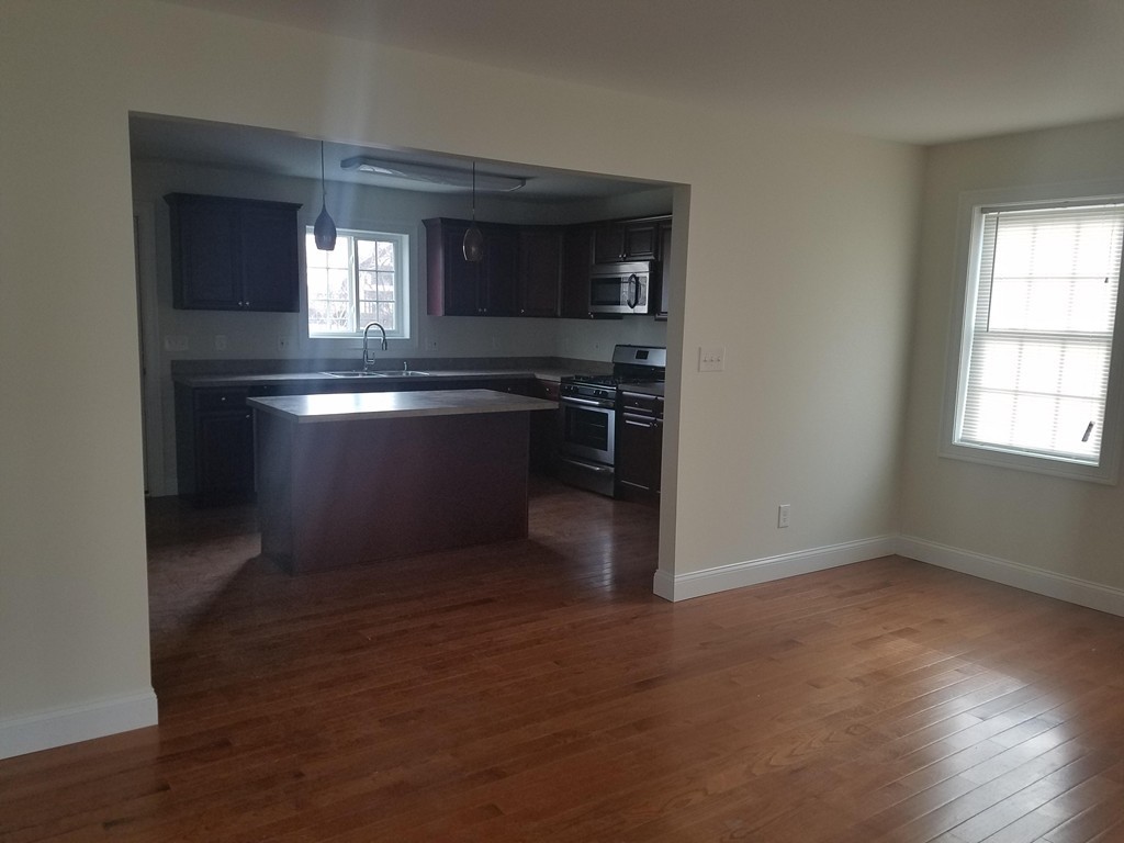 23 Beech Street Springfield, MA 01105 - Photo 5 of 10 a kitchen with a refrigerator and window