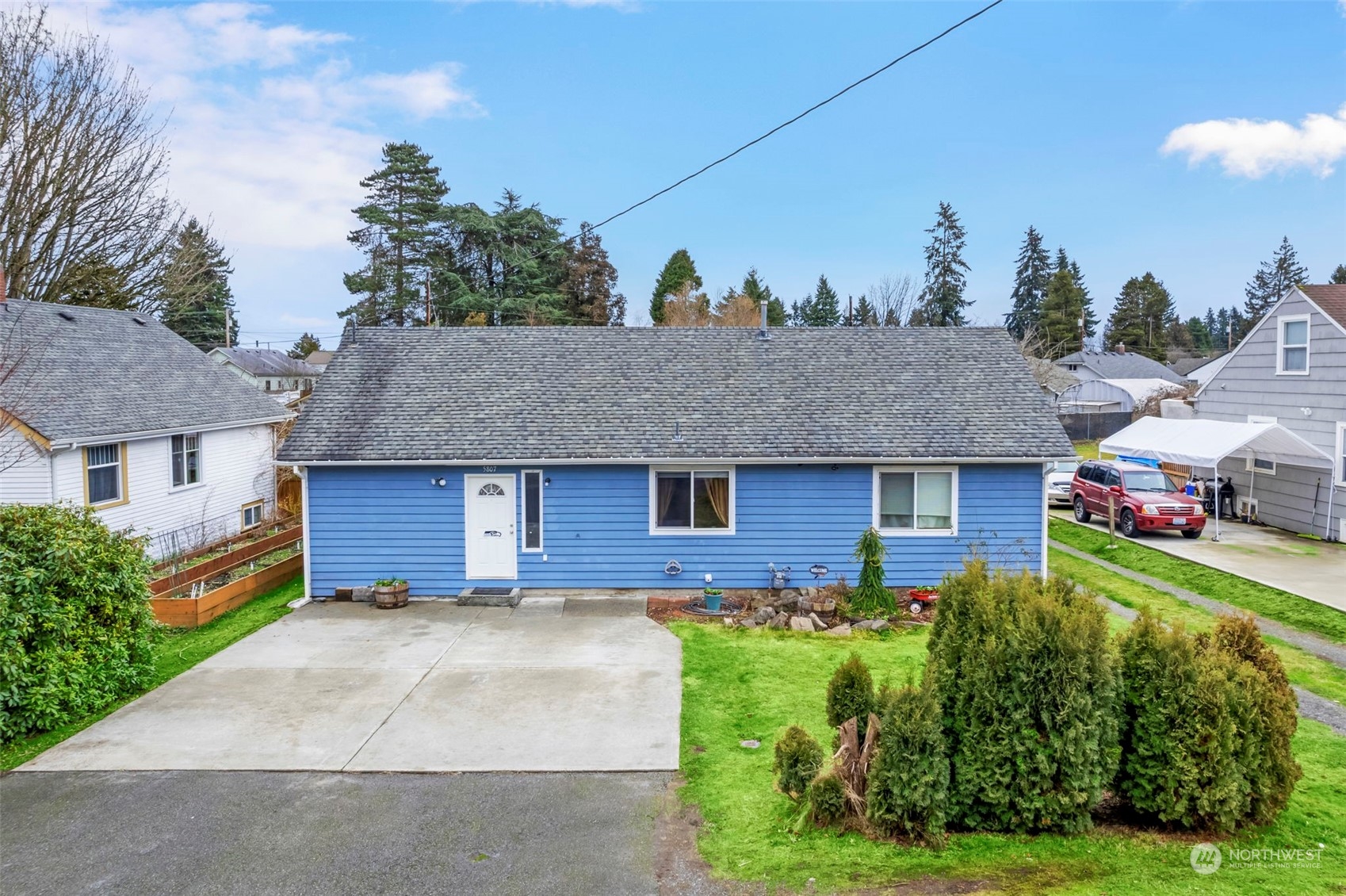 5807 Lowell Road Everett, WA 98203 - Photo 1 of 30 a front view of a house with a yard and garage