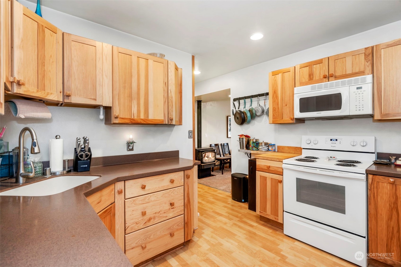 5807 Lowell Road Everett, WA 98203 - Photo 10 of 30 a kitchen with stainless steel appliances granite countertop white cabinets a sink a stove and a microwave