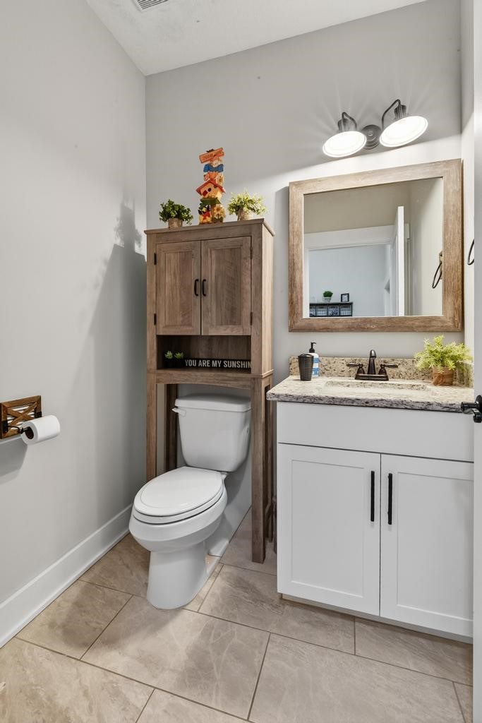 75774 Edwards Road Yulee, FL 32097 - Photo 38 of 70 a bathroom with a toilet sink and mirror
