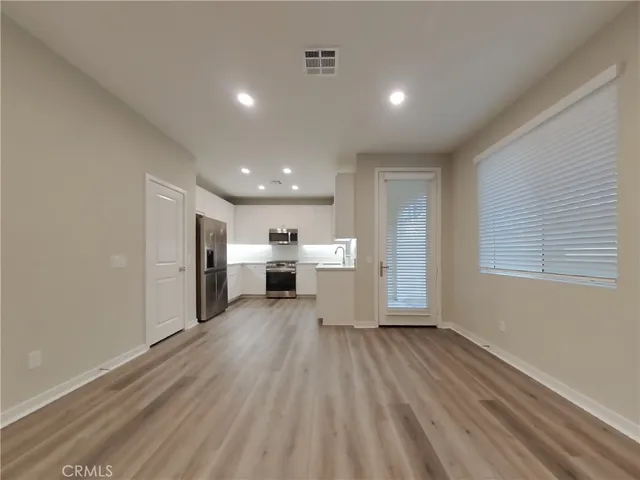 a view of a kitchen with wooden floor