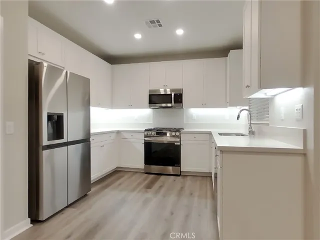 a kitchen with a refrigerator sink and stove