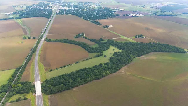 an aerial view of a house with a yard and lake view