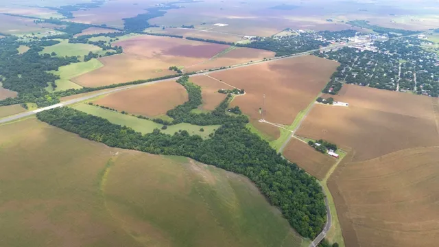 an aerial view of a house with a yard and lake view