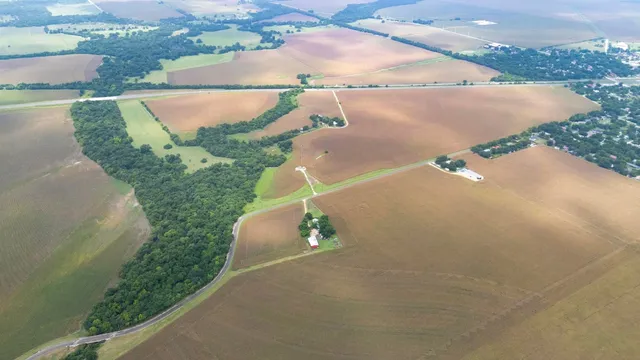 an aerial view of a house with a yard and lake view