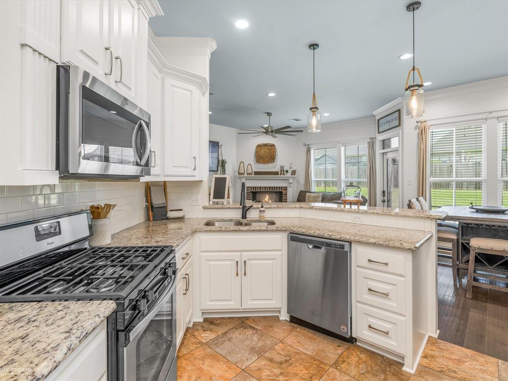 690 Lessie Drive Stonewall, LA 71078 - Photo 12 of 29 Open-concept kitchen featuring white cabinetry, stainless steel appliances, and a gas range