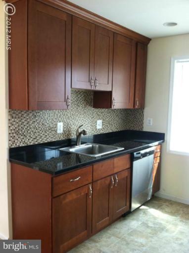 233 Arden Road West Baltimore, MD 21225 - Photo 2 of 10 a kitchen with granite countertop cabinets and sink