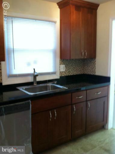 233 Arden Road West Baltimore, MD 21225 - Photo 3 of 10 a kitchen with a sink a window and cabinets