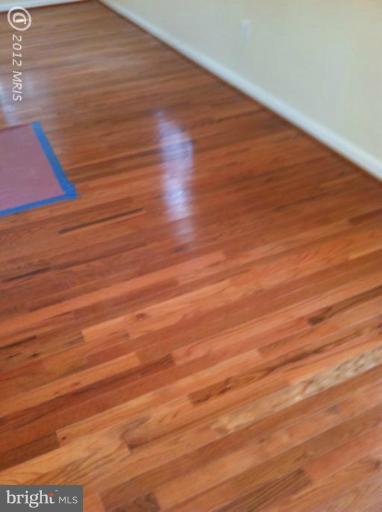 233 Arden Road West Baltimore, MD 21225 - Photo 4 of 10 a view of room with wooden floor