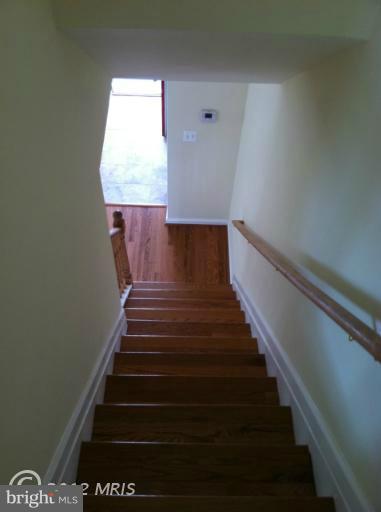 233 Arden Road West Baltimore, MD 21225 - Photo 8 of 10 a view of entryway and hall with wooden floor
