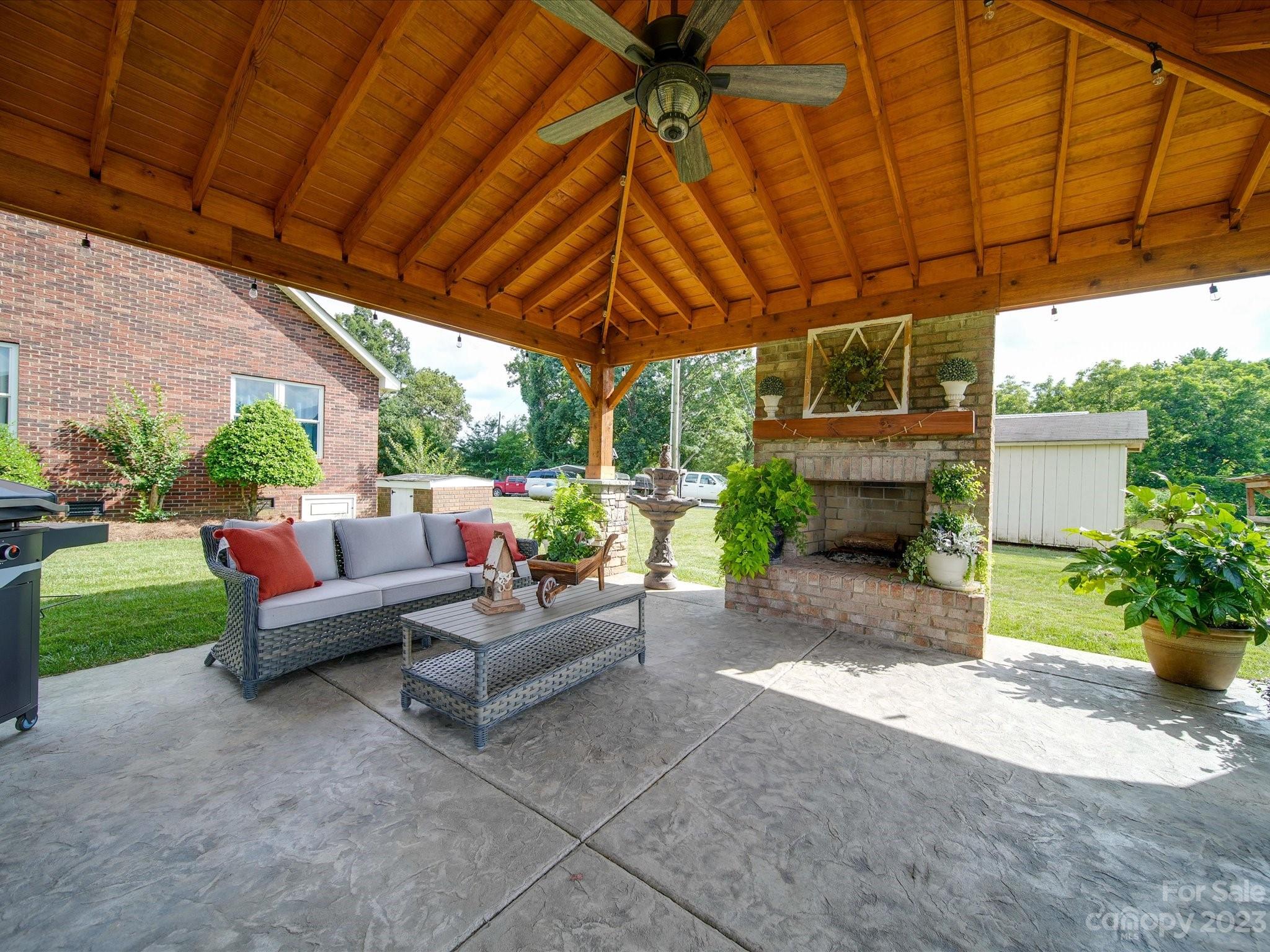 5817 Unionville Road Monroe, NC 28110 - Photo 14 of 46 a view of patio with a table and chairs under an umbrella