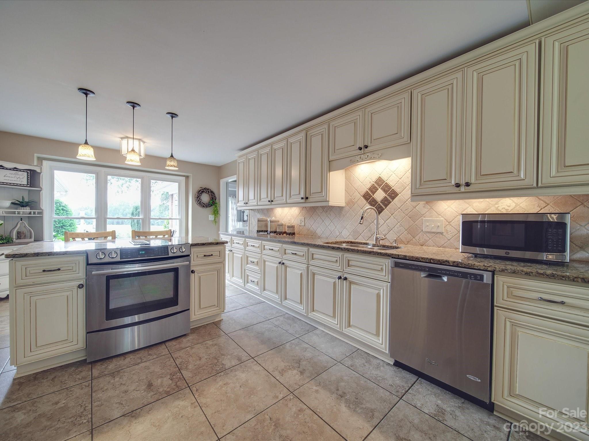 5817 Unionville Road Monroe, NC 28110 - Photo 24 of 46 a kitchen with stainless steel appliances granite countertop a stove sink and cabinets