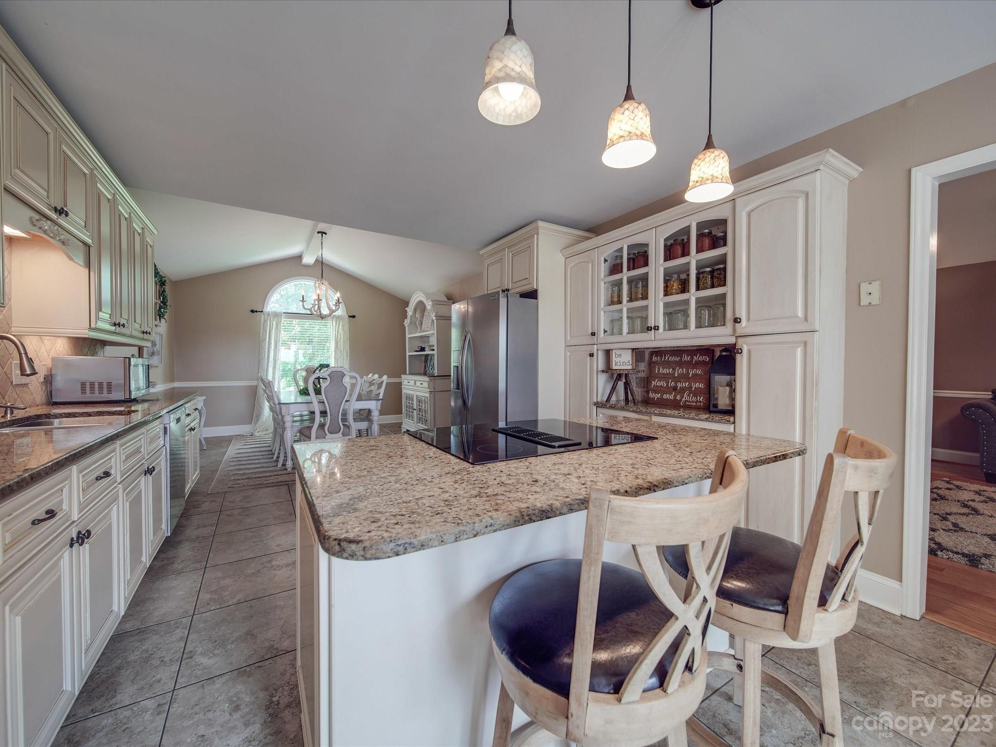 5817 Unionville Road Monroe, NC 28110 - Photo 25 of 46 a kitchen with stainless steel appliances granite countertop a stove a kitchen island a dining table and chairs