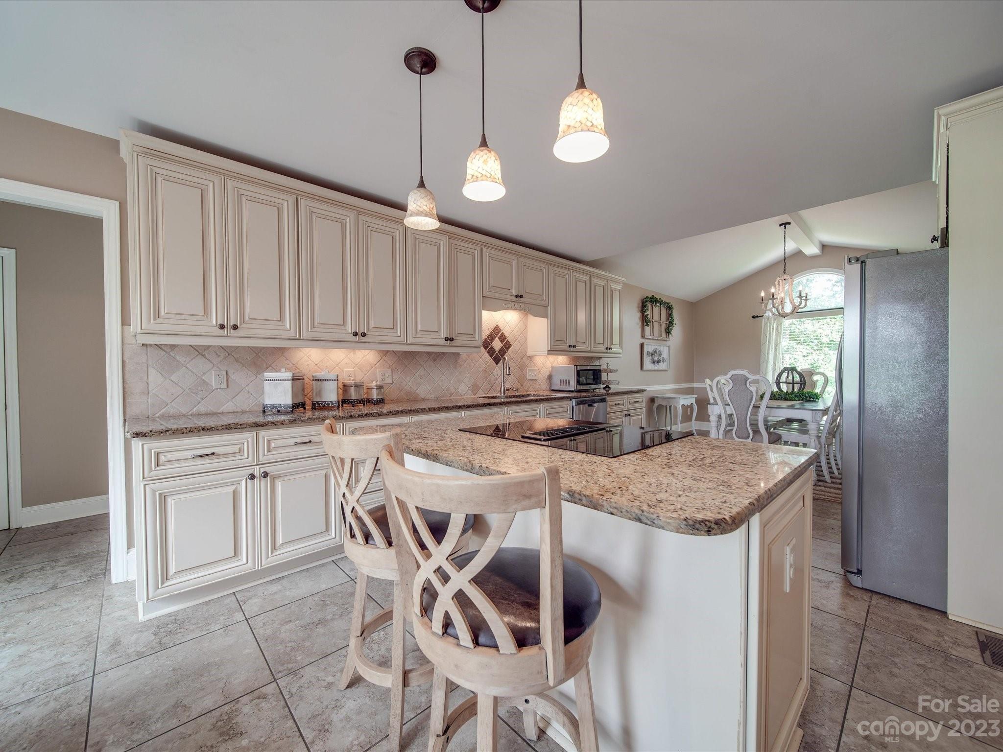 5817 Unionville Road Monroe, NC 28110 - Photo 26 of 46 a kitchen with kitchen island granite countertop a sink a center island and cabinets