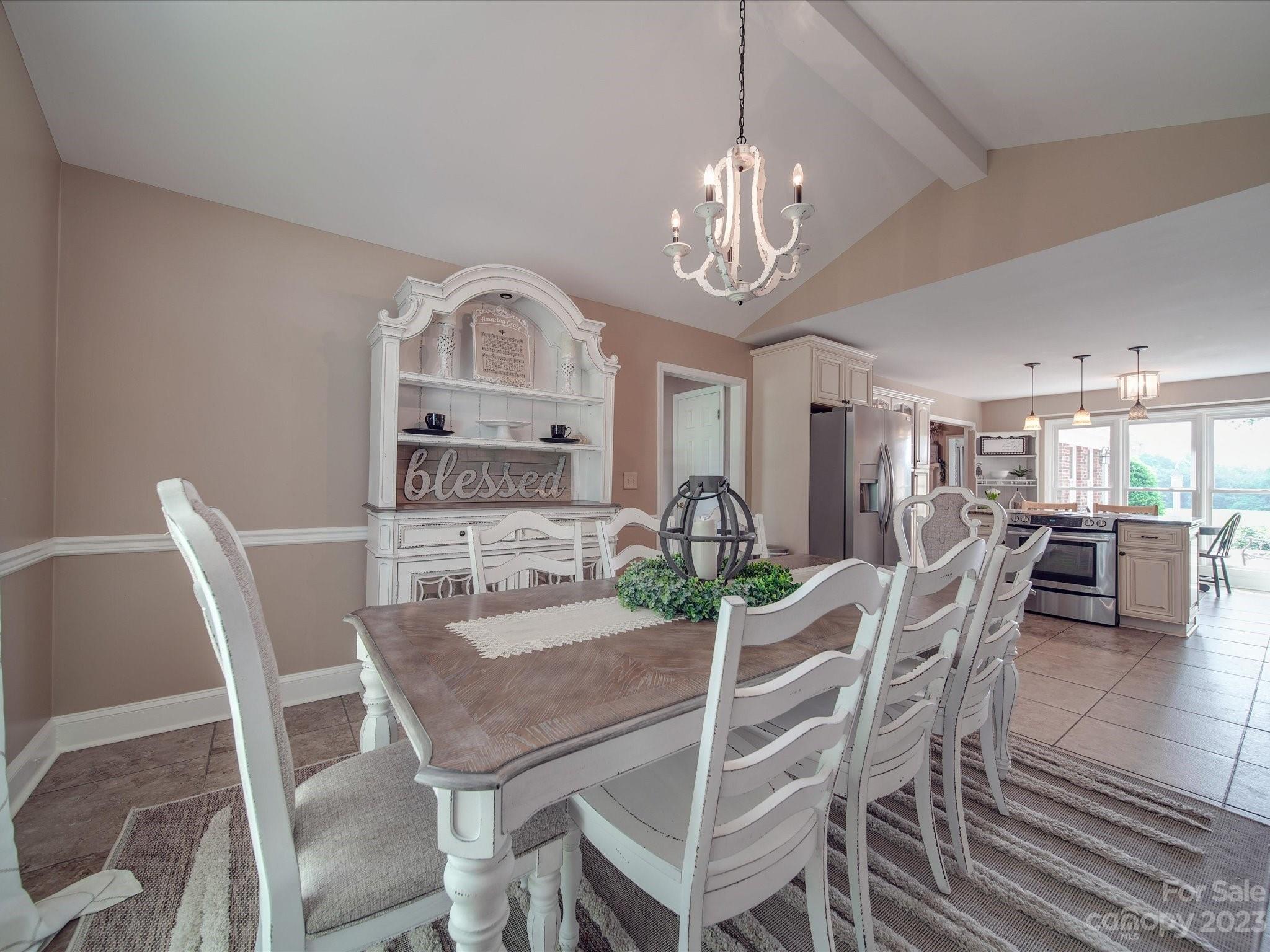 5817 Unionville Road Monroe, NC 28110 - Photo 28 of 46 a view of a dining room with furniture a chandelier and wooden floor