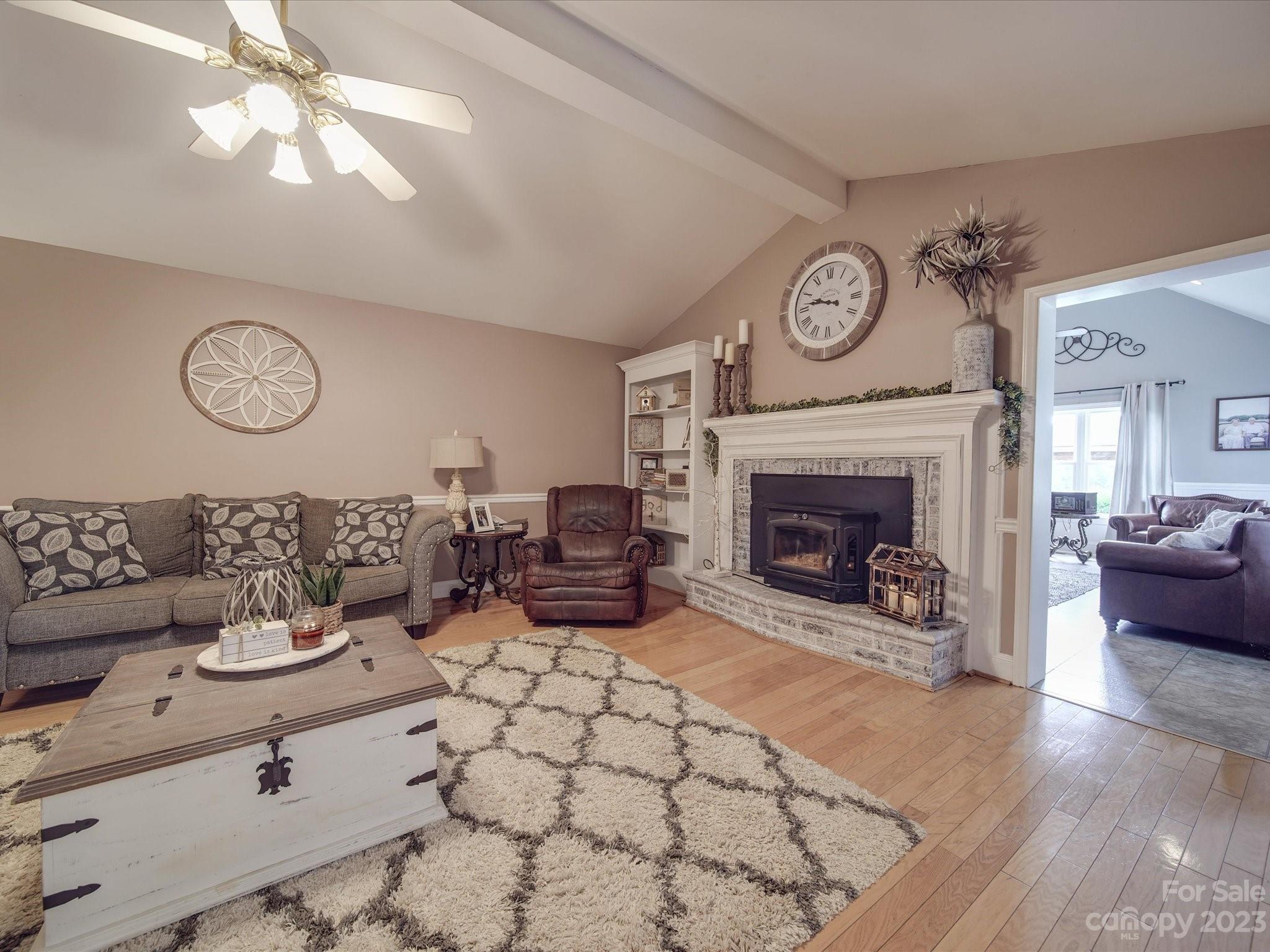 5817 Unionville Road Monroe, NC 28110 - Photo 32 of 46 a living room with furniture a clock and a fireplace