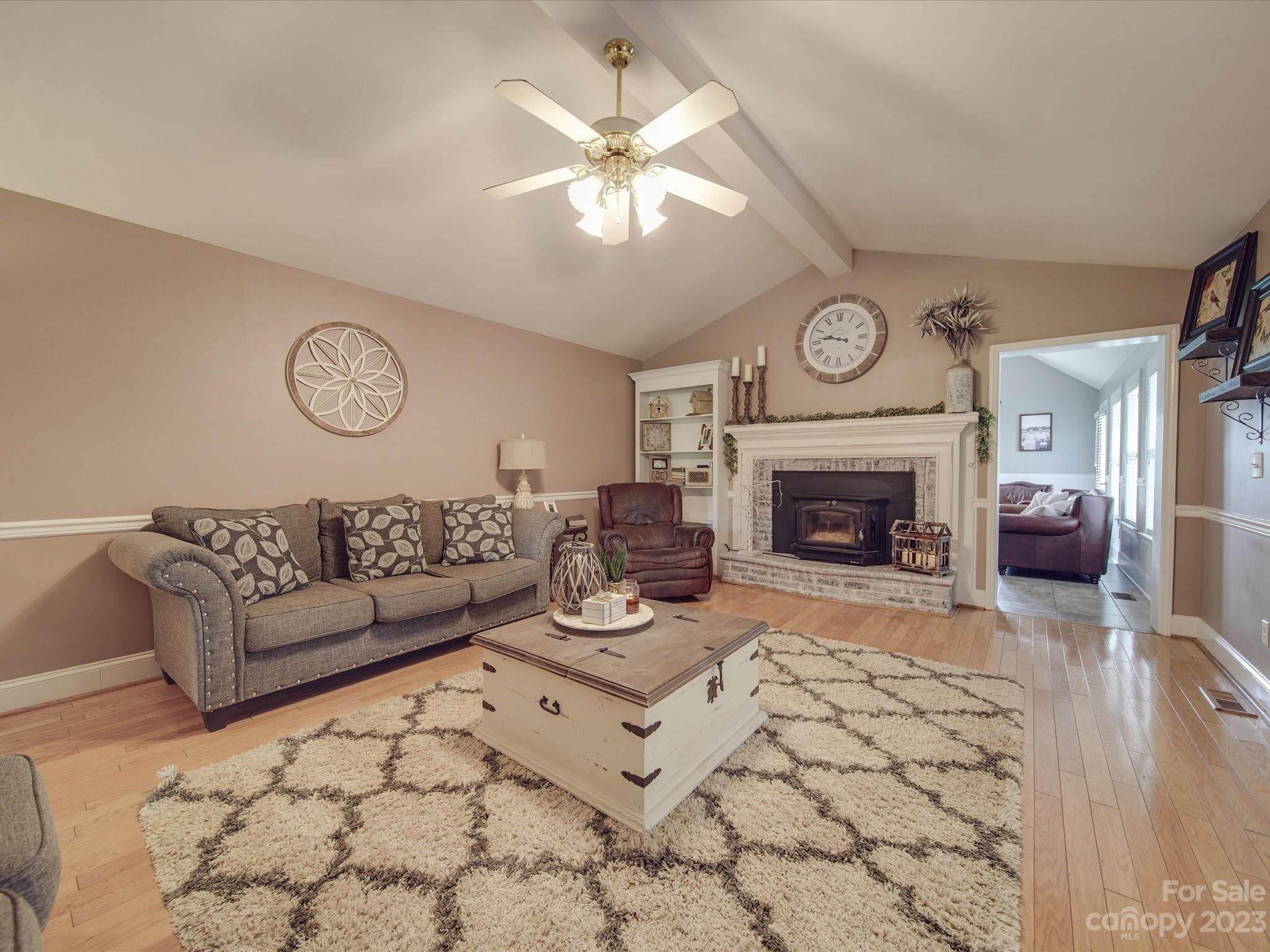 5817 Unionville Road Monroe, NC 28110 - Photo 34 of 46 a living room with furniture a clock and a fireplace