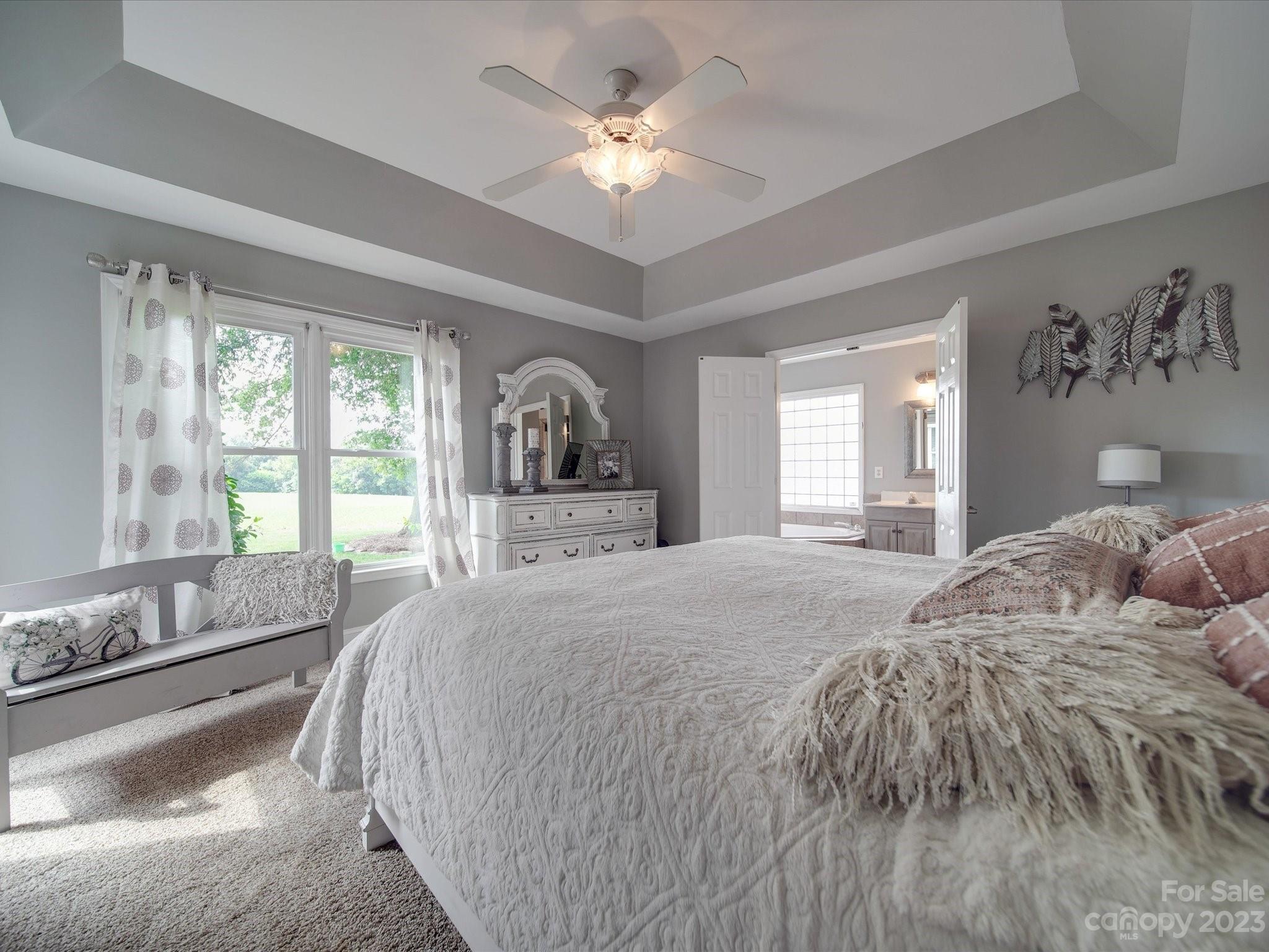 5817 Unionville Road Monroe, NC 28110 - Photo 35 of 46 a spacious bedroom with a large bed and a large window