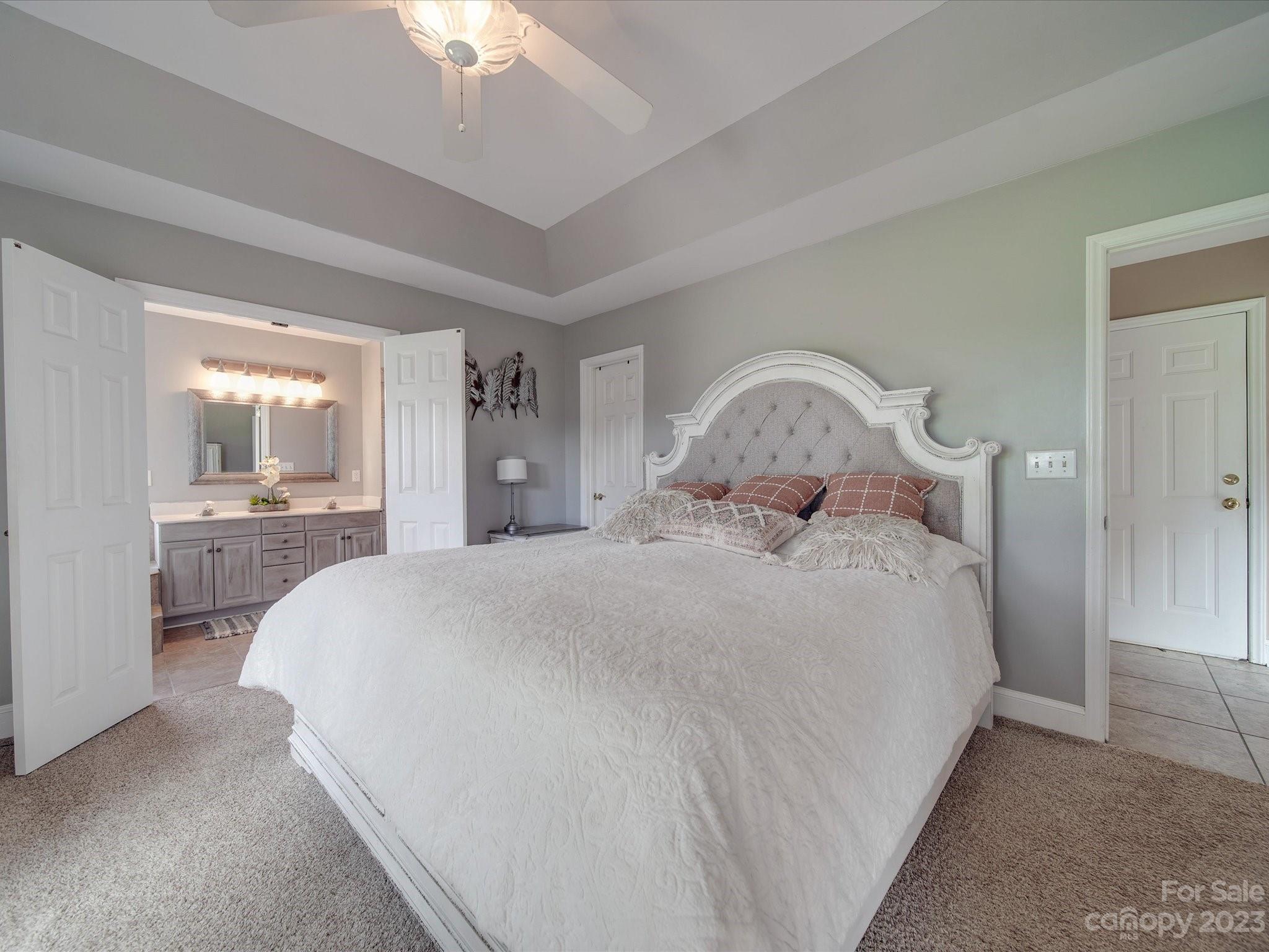 5817 Unionville Road Monroe, NC 28110 - Photo 36 of 46 a bedroom with a large bed and a chandelier