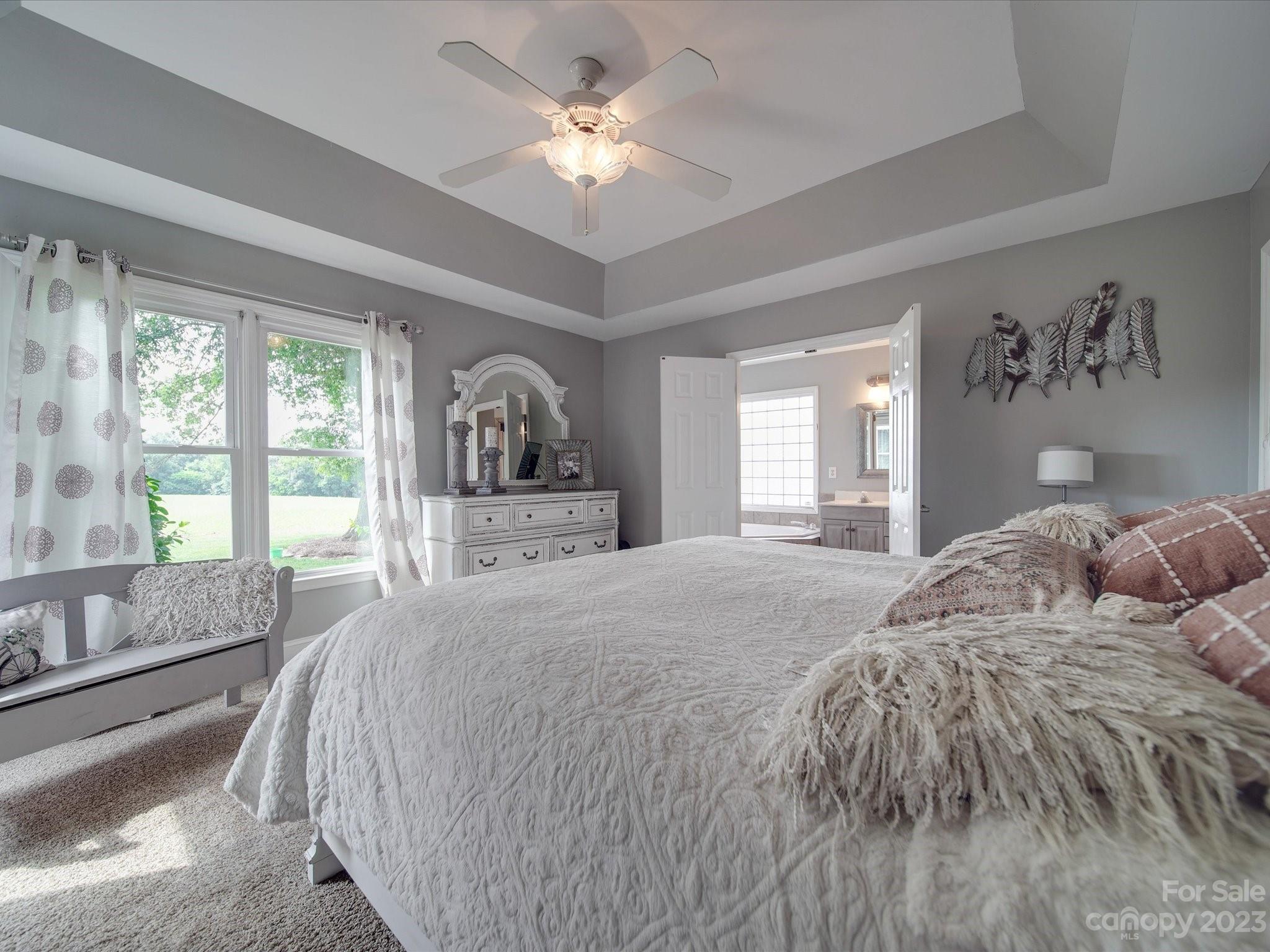 5817 Unionville Road Monroe, NC 28110 - Photo 37 of 46 a spacious bedroom with a large bed and a large window