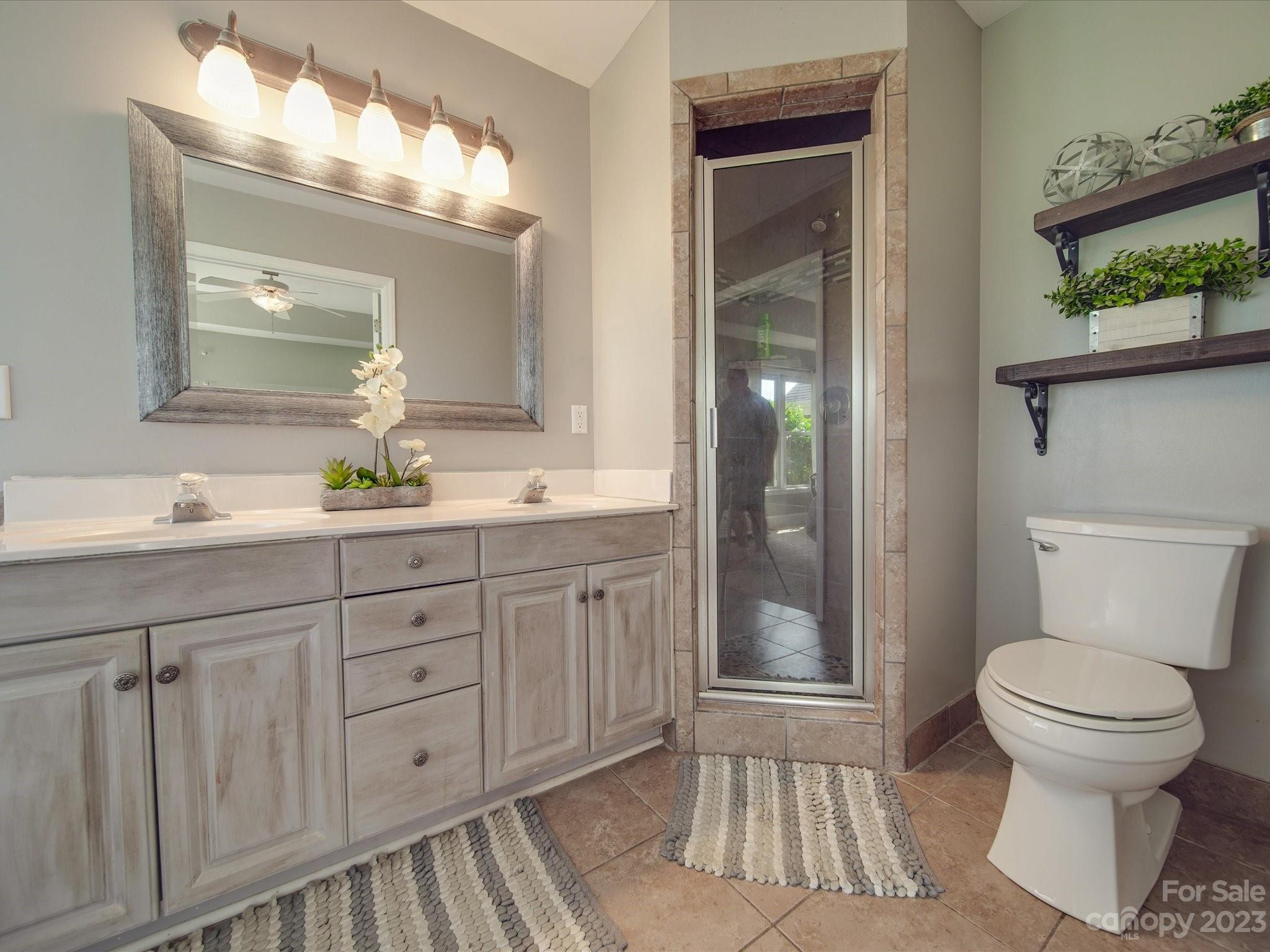 5817 Unionville Road Monroe, NC 28110 - Photo 38 of 46 a bathroom with a toilet a sink and mirror